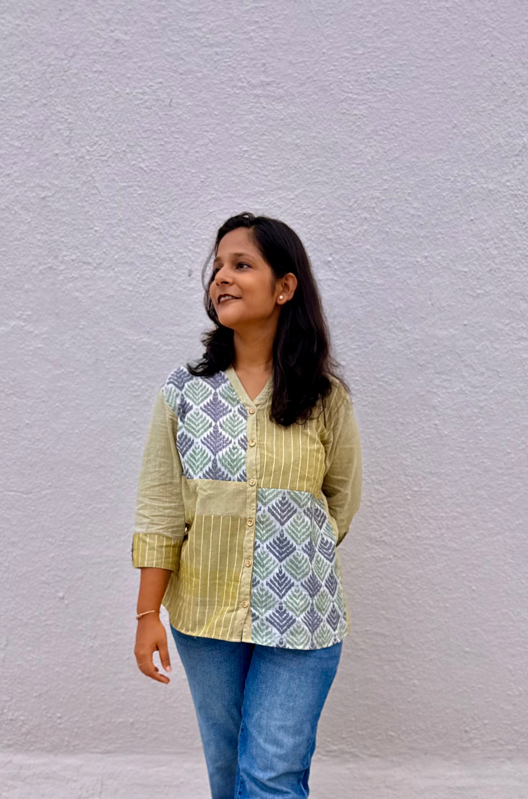 Saaj mustard handloom cotton shirt worn with jeans, standing front view