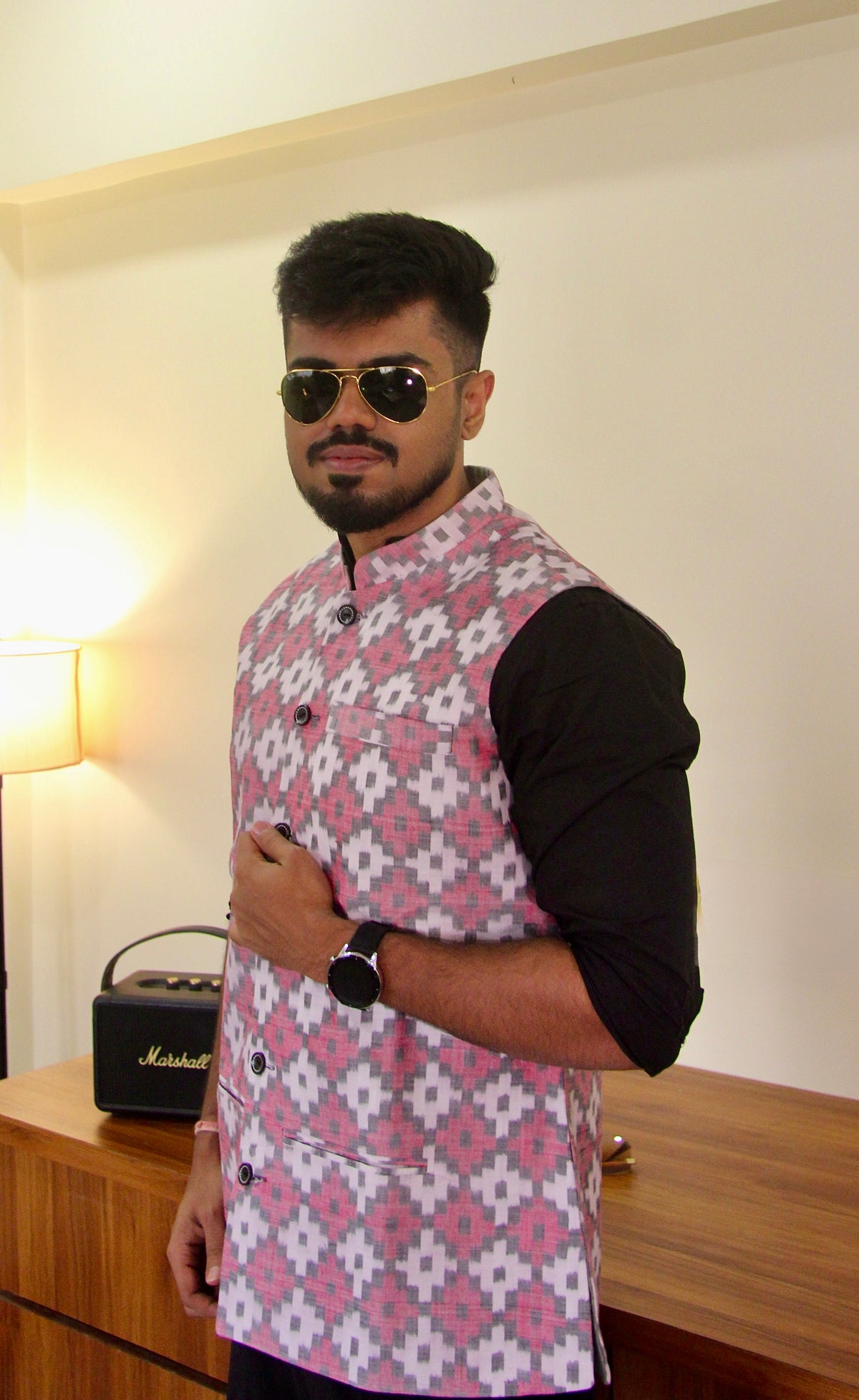 Do Dil reversible handloom jacket for men, pink ikat side worn over a black kurta, front view