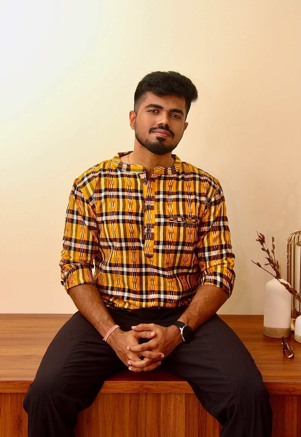 Kaali Peeli yellow and black checked Sambalpuri ikat handloom kurta for men, seated front view