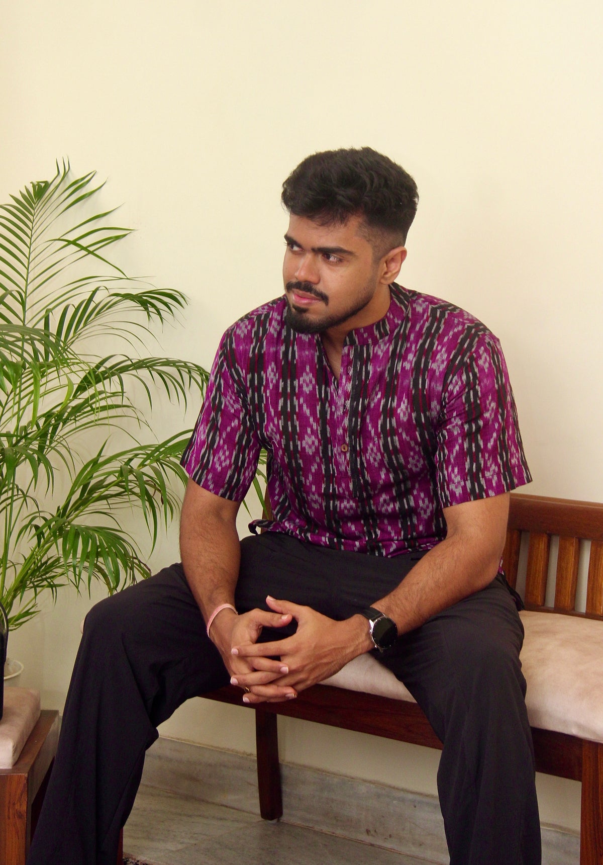 Kaala Jamun purple Sambalpuri ikat handloom kurta for men worn with black trousers, seated