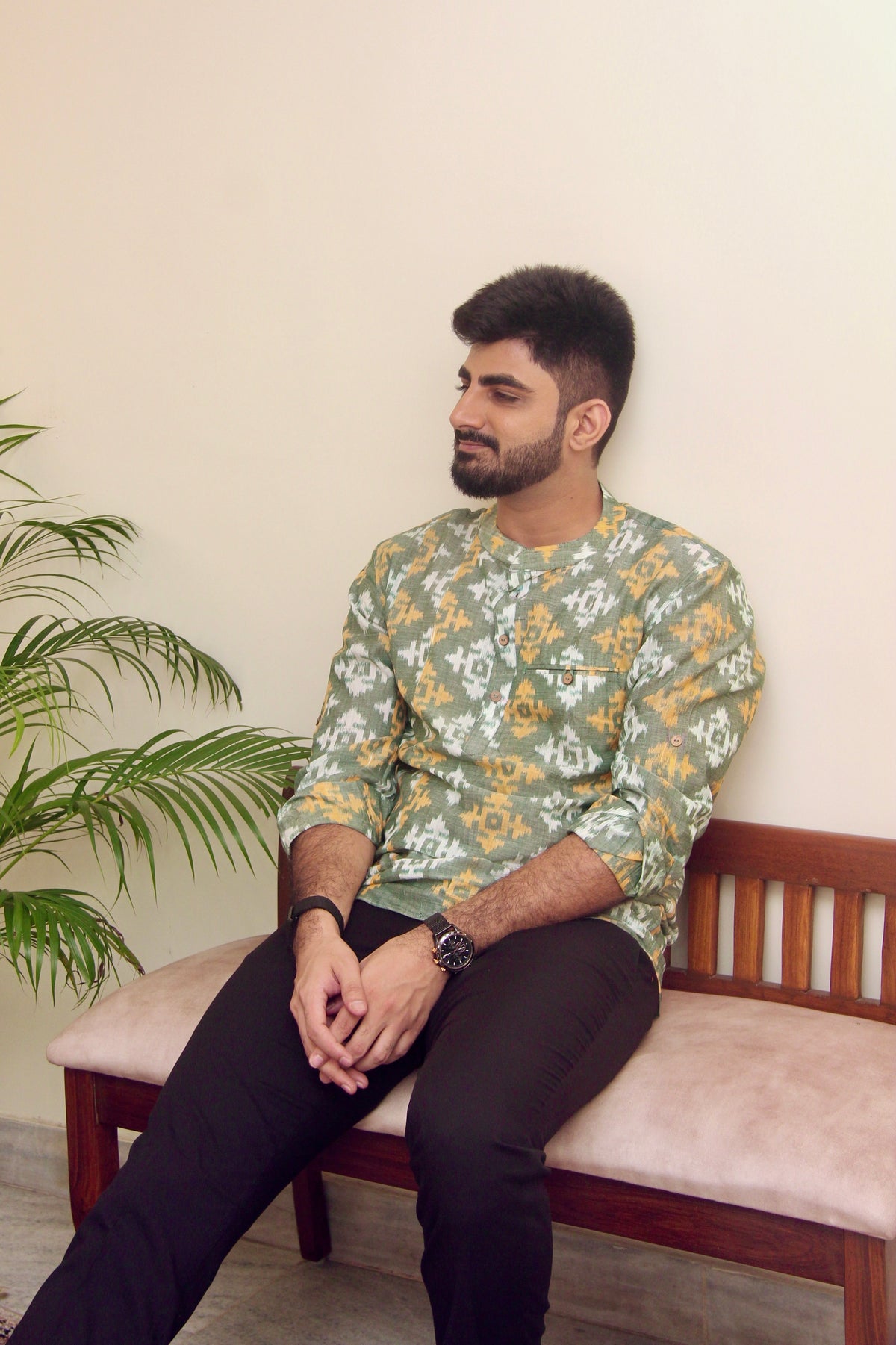 Mann Mauji sage green Sambalpuri ikat handloom kurta for men, seated front view on a bench
