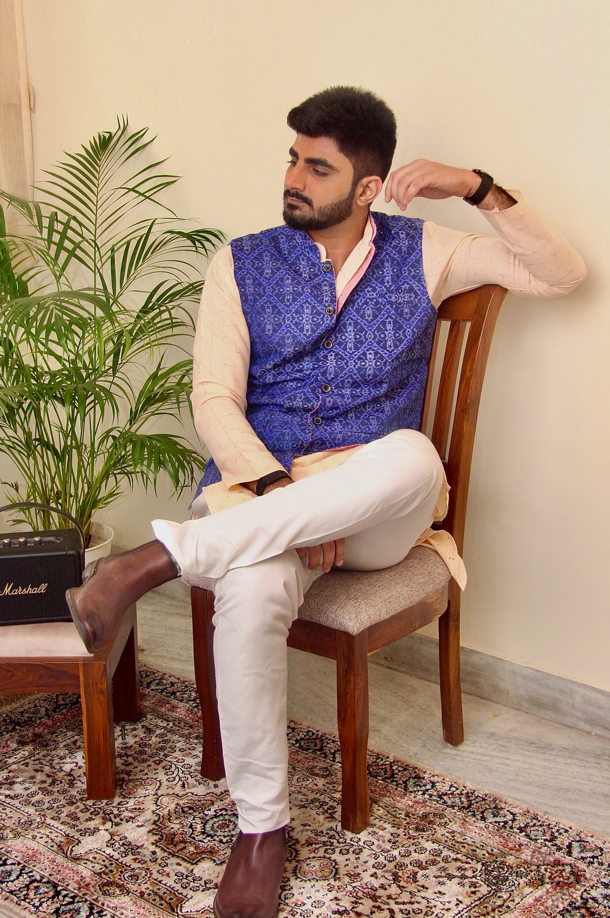 Shaam Savera reversible handloom jacket for men, blue ikat side, seated front view