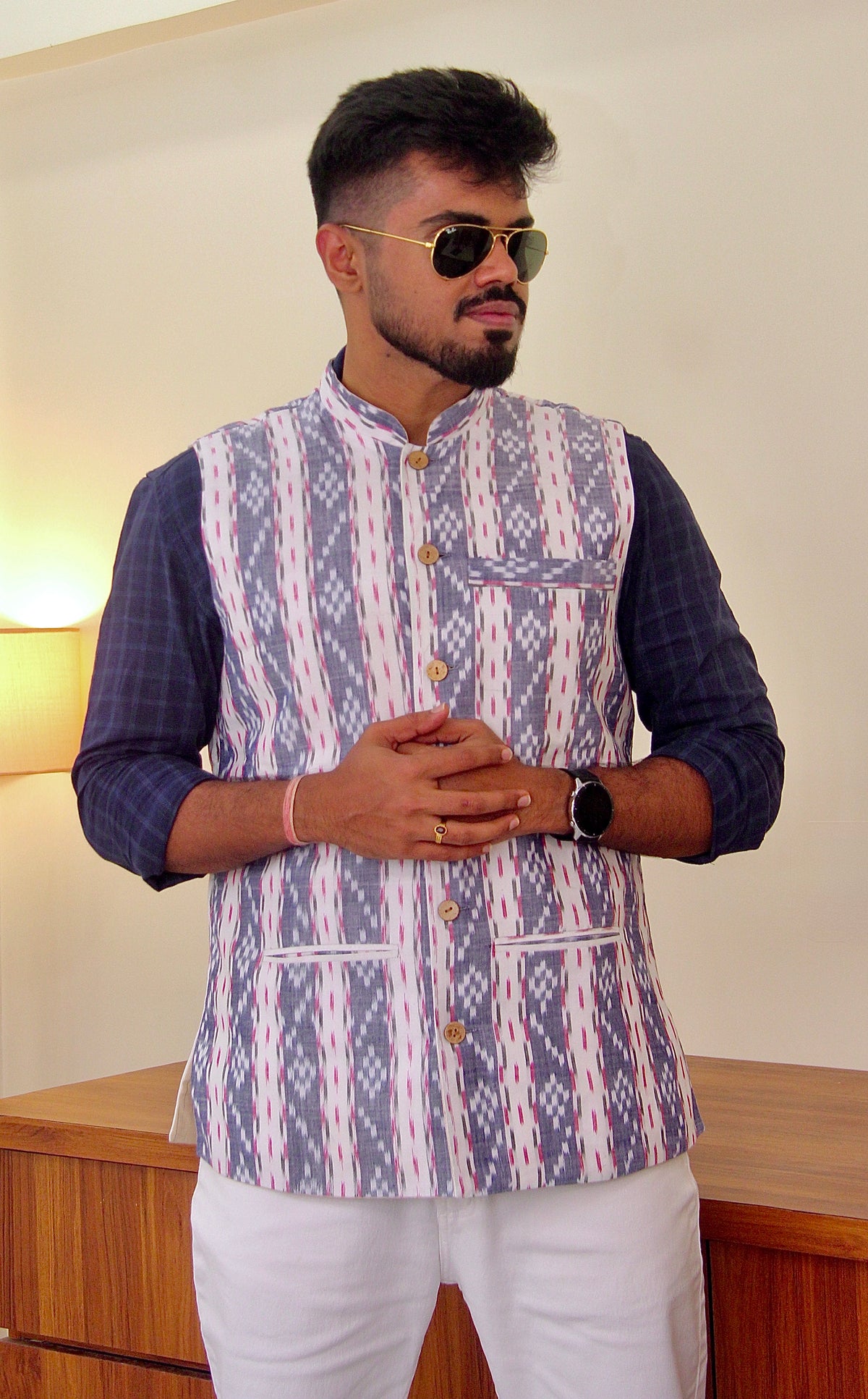Sagar Kinaare reversible handloom jacket for men, blue ikat side worn over a navy kurta, front view