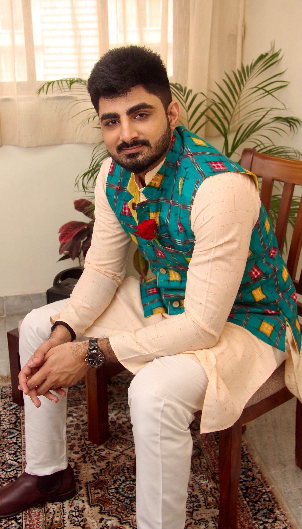 Kacchi Keri reversible handloom jacket for men, teal ikat side worn over a cream kurta, seated