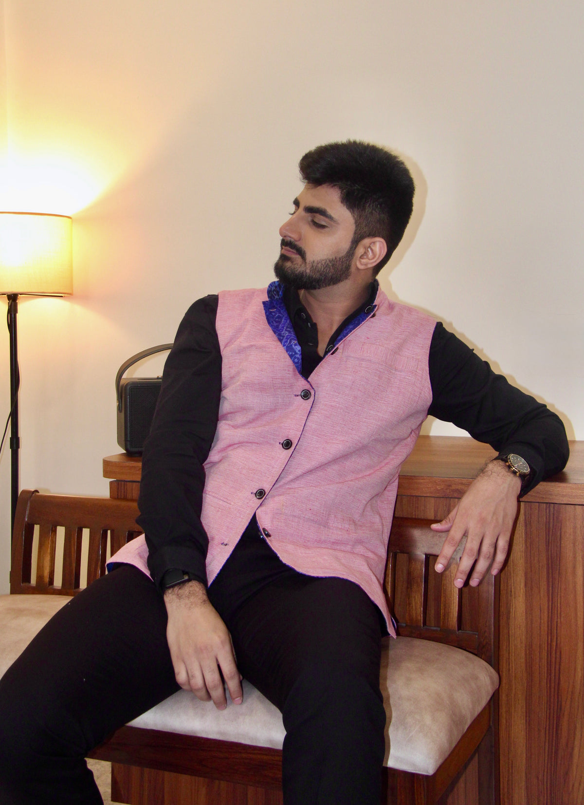 Shaam Savera reversible handloom jacket for men, pink reverse side, seated three-quarter view