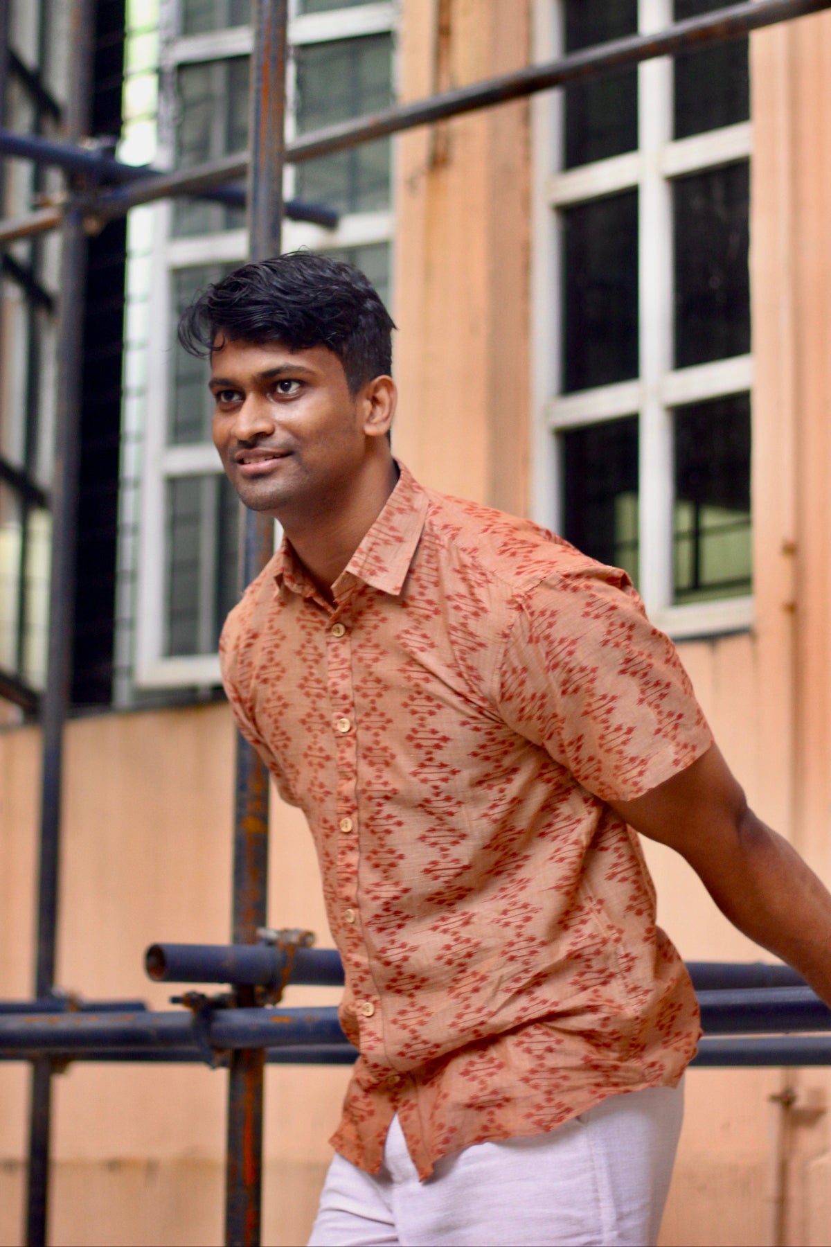 Kora terracotta Nuapatna ikat handloom shirt for men, seated front view