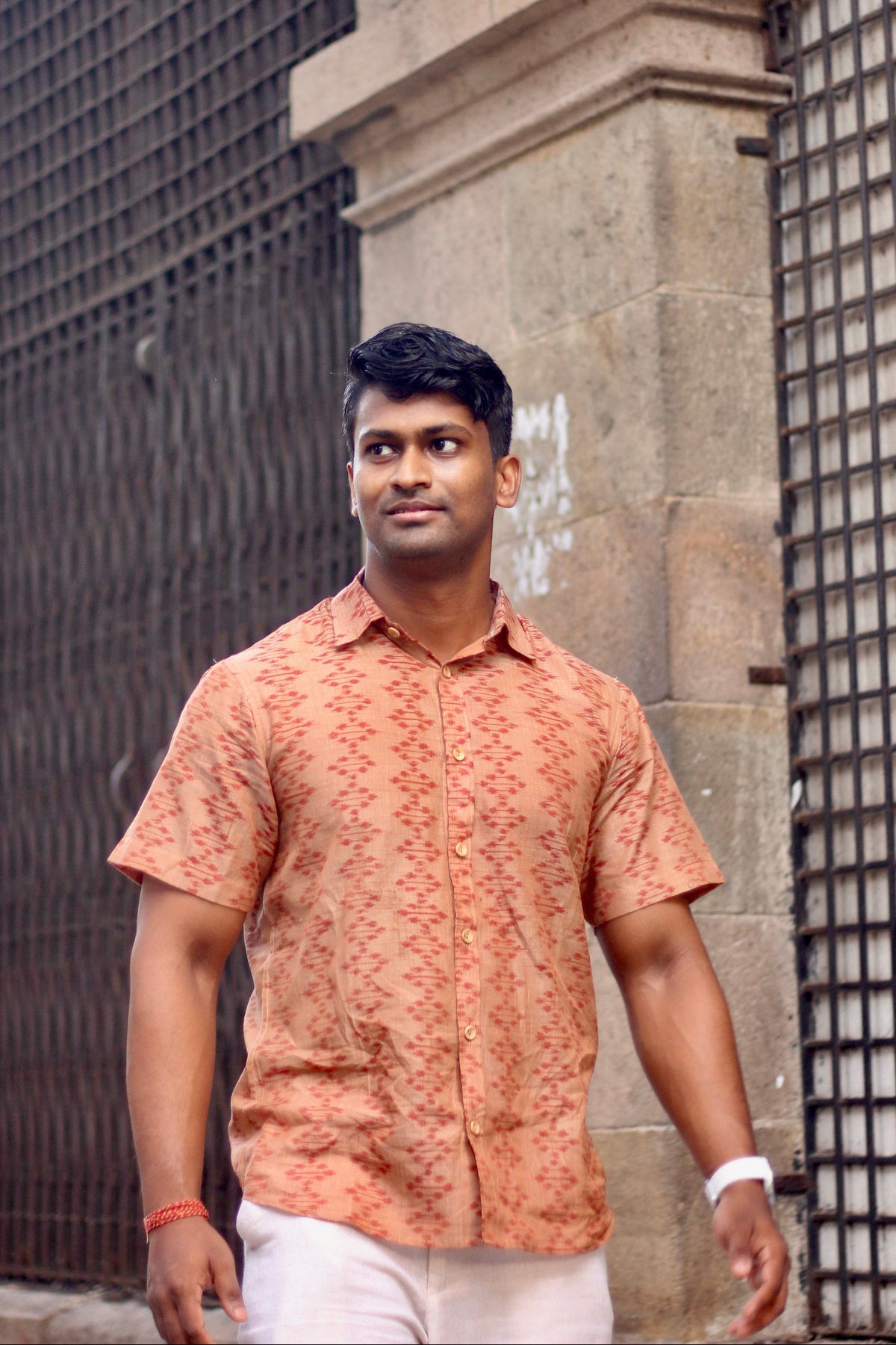 Kora terracotta Nuapatna ikat handloom shirt for men worn with cream trousers, full length