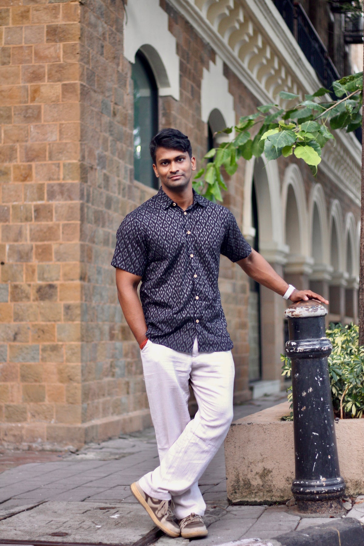 Nishith navy Nuapatna ikat handloom shirt for men worn with cream trousers, full length