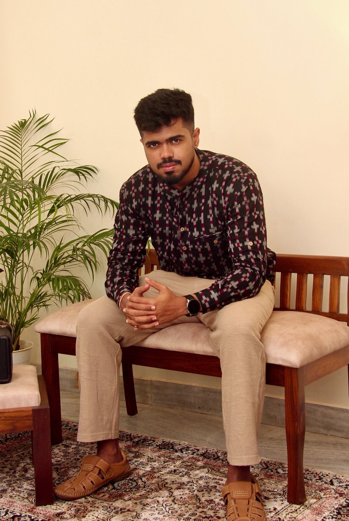 Aankh Micholi dark brown Sambalpuri ikat handloom kurta for men, seated view showing the ikat motifs