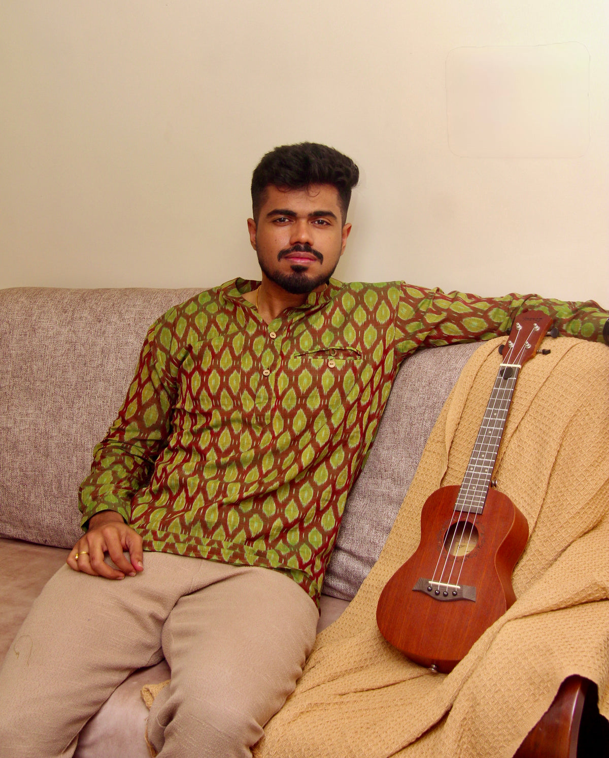 Aam Panna olive green Sambalpuri ikat handloom kurta for men, seated three-quarter view
