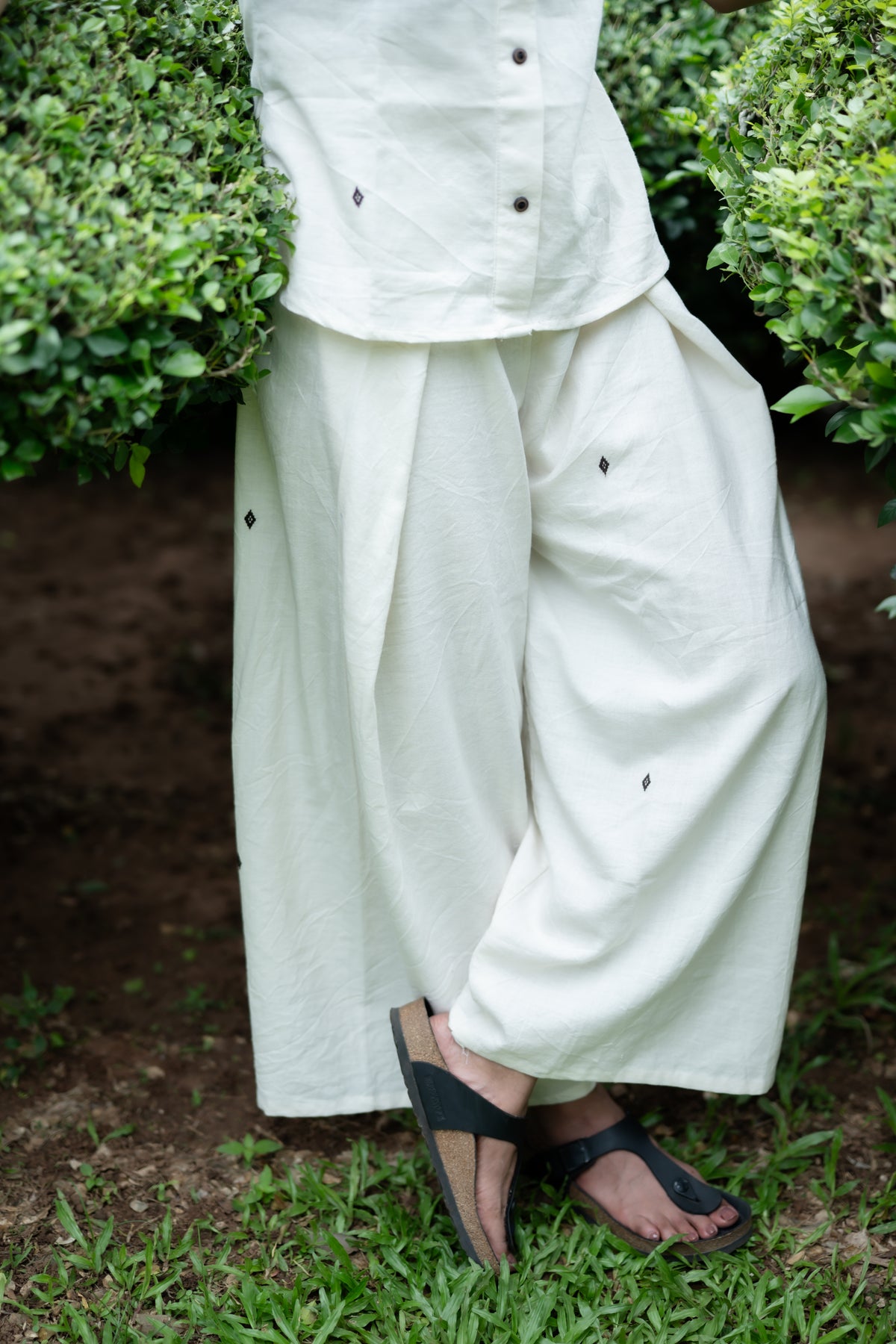Baisali cream Kotpad handloom tie-on wide-leg trousers, side view showing the drape