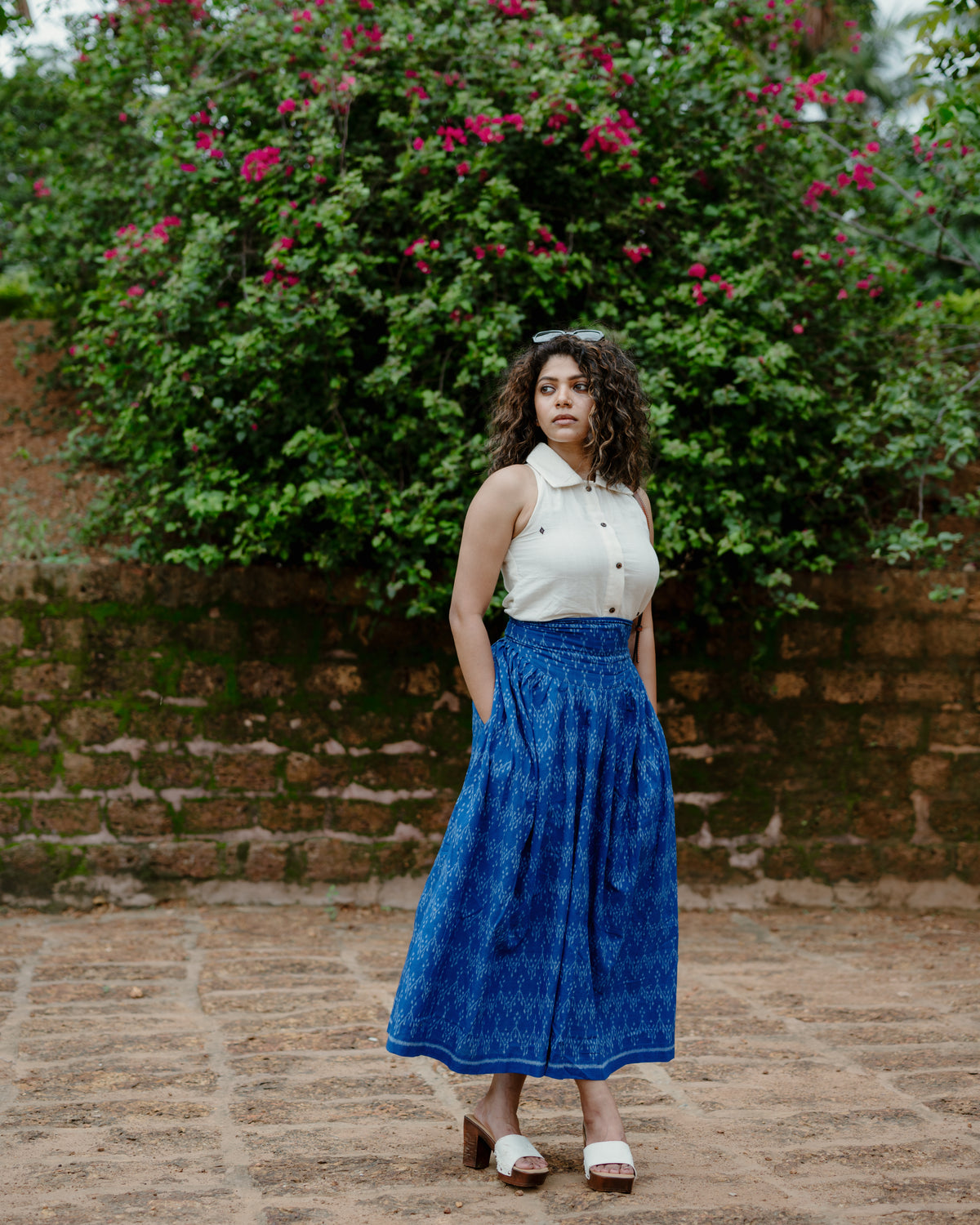 Avani blue Nuapatna handloom corset skirt worn with a cream shirt, full length front view